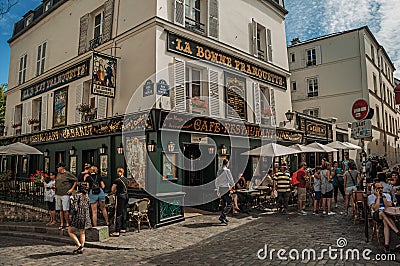 People having fun in Montmartreâ€™s restaurant in sunny day at Paris. Editorial Stock Photo